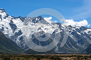 The massive mountains with glacier in a peaceful summer day with fresh blue sky at Mount Cook National Park, New Zealand