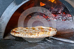 Massive oven for pizza on firewood with pizza