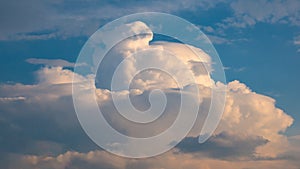 Massive rain cloud - cumulus congestus or towering cumulus - forming in the blue sky