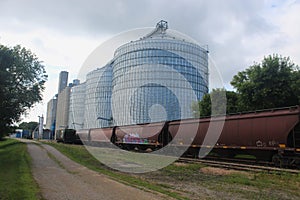 Massive Steel and Concrete Grain Elevators with Rail Cars in Front