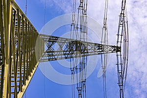 Massive steel power pole with many overhead lines for electricity