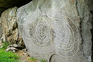 Massive stone with prehistoric carvings