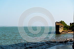 Massive stone wall in the middle of the blue ocean