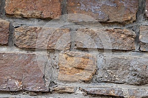 Massive stone wall with rough rocks like a castle wall with different bricks as natural background and rocky wall of ancient times