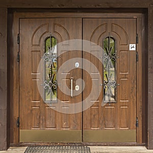 massive two-leaf wooden entrance door from the street.