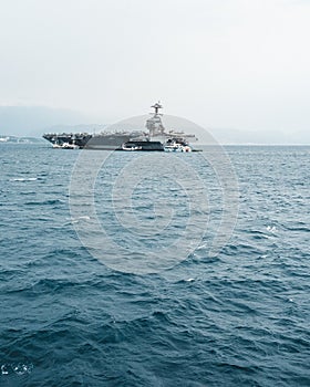 Massive vessel sails alongside another ship in the vast ocean