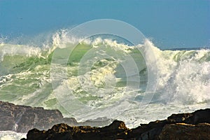 Massive waves crashing onto the rocky coastline of Storms River Nature Reserve.
