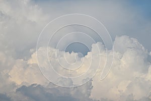 Massive white clouds over blue sky