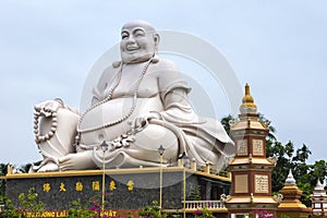 Massive white Sitting Buddha statue at Vinh Trang Pagoda, Vietnam.