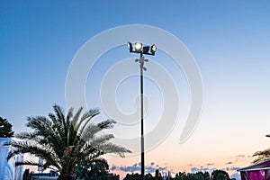 Mast at the beach with four spotlights and four cameras attached.