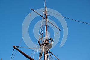 Mast, crow`s nest and rigging on replica of vintage 16th century sailing ship `Nau Quinhentista` in Vila do Conde, Portugal