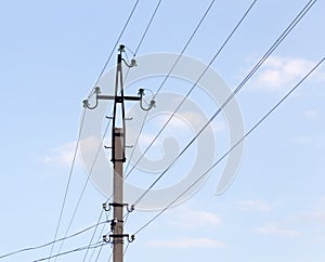 Mast electrical power line against cloud and blue sky