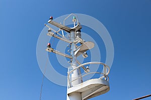 The mast of a large ship with navigation equipment bottom view. signal lights,  and equipment.