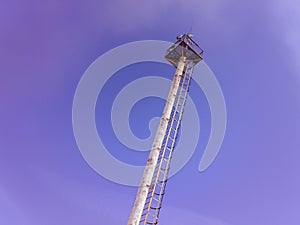 Mast lighting on a blue sky . Mast with lightning rod and observation platform