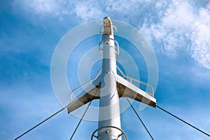The mast of a modern ship against the background of the blue sky