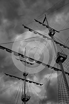 The mast of an old sailboat against the background of clouds of a stormy sky