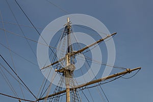 Mast of an old sailing vessel, rigging lines with block and tackle