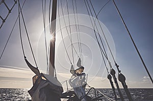Mast of an old schooner sailing at sunset