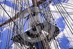 Mast, rigging and folded sails of a classic sailing ship.