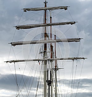 Mast, rigging and furled sails on a tall ship / sailing ship