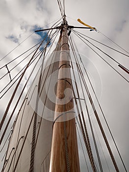 Mast, ropes and sails collected from an old sailboat seen from below photo