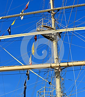 Mast of sailing ship against blue sky