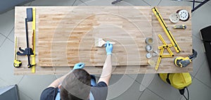 Master apply wood preservative with brush at workplace.