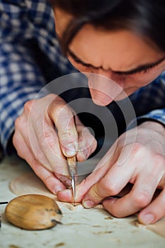 Master artisan luthier working on the creation of a violin. painstaking detailed work on wood.