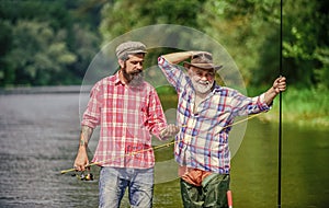 Master baiter. Mature man with friend fishing. Summer vacation. Happy cheerful people. Fisherman with fishing rod