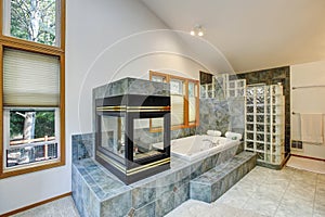 Master bathroom interior with tile flooring and fireplace