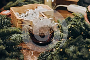 Master class on creating a Christmas wreath. Glass kettle with delicious brewed tea