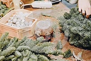 Master class on creating a Christmas wreath. Glass kettle with delicious brewed tea