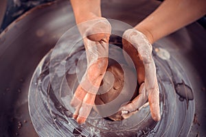 Master class on modeling of clay on a potter`s wheel In the pottery workshop