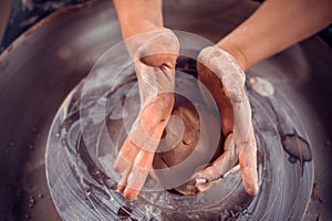 Master class on modeling of clay on a potter& x27;s wheel In the pottery workshop