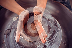 Master class on modeling of clay on a potter& x27;s wheel In the pottery workshop