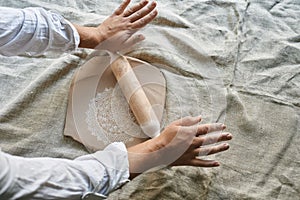 master craftsman rolls the clay on the table, transfers the napkin pattern to the clay mass