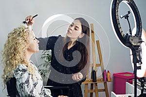 Master does a beautiful blonde makeup in a beauty salon