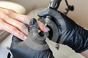 The master does hardware manicure. photo