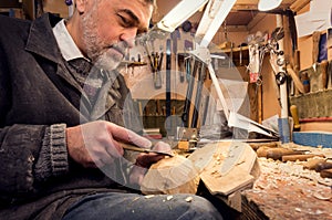 Master examines wood carvings, the carpenter checks the finished