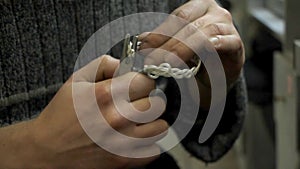 The master jeweler holds the working tool in his hands and makes jewelery at his workplace