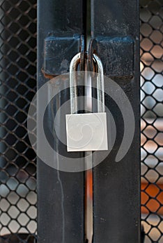 Master key silver lock on the black iron door.