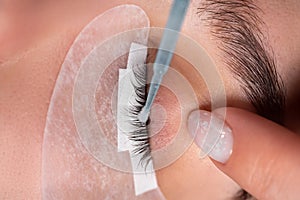 master lash maker performs eyelash degreasing close-up. Eyelash extension procedure.