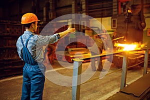 Master looks on steelmaking process in furnace