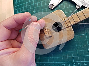 Master makes a guitar for a doll
