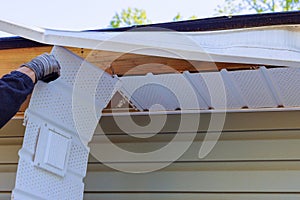 Master makes repairs after a hurricane damages fascia trim