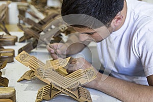 Master making creating ingenious rihals wooden book stands from Bukhara, Uzbekistan.