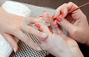 Master of manicure makes nail extensions gel in the beauty salon.