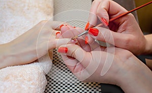 Master of manicure makes nail extensions gel in the beauty salon photo