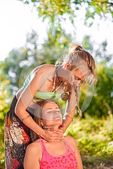 Master massage therapist applies her massage skills on her client in nature.