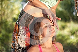 Master massage therapist applies her massage skills on her client in the sunlight.
